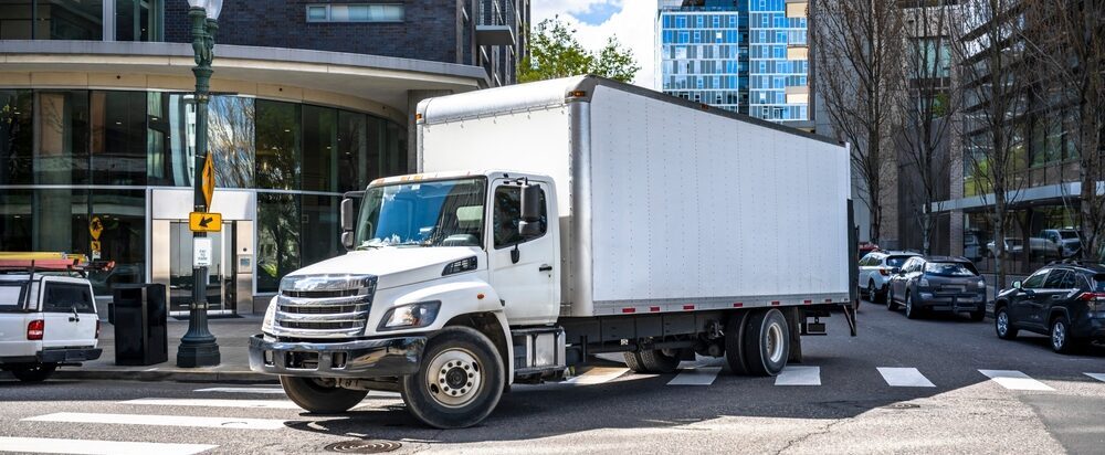 box truck driving in a city