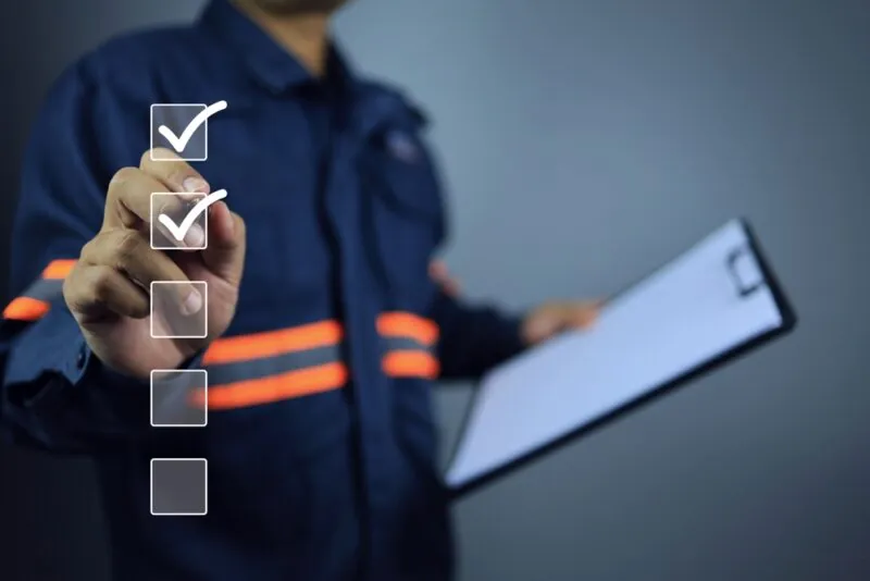 worker holding a International Shipping Checklist