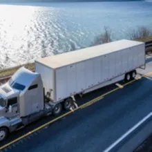 dry van freight in front of a large body of water