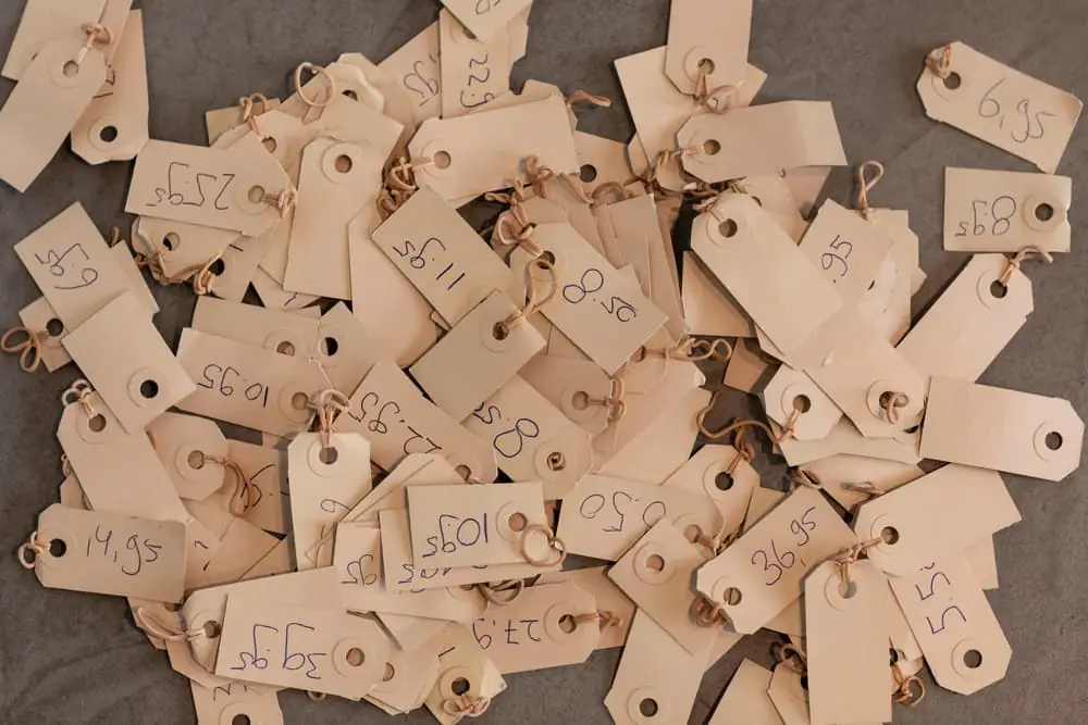 Dynamic Pricing big pile of brown price tags with handwritten prices on them