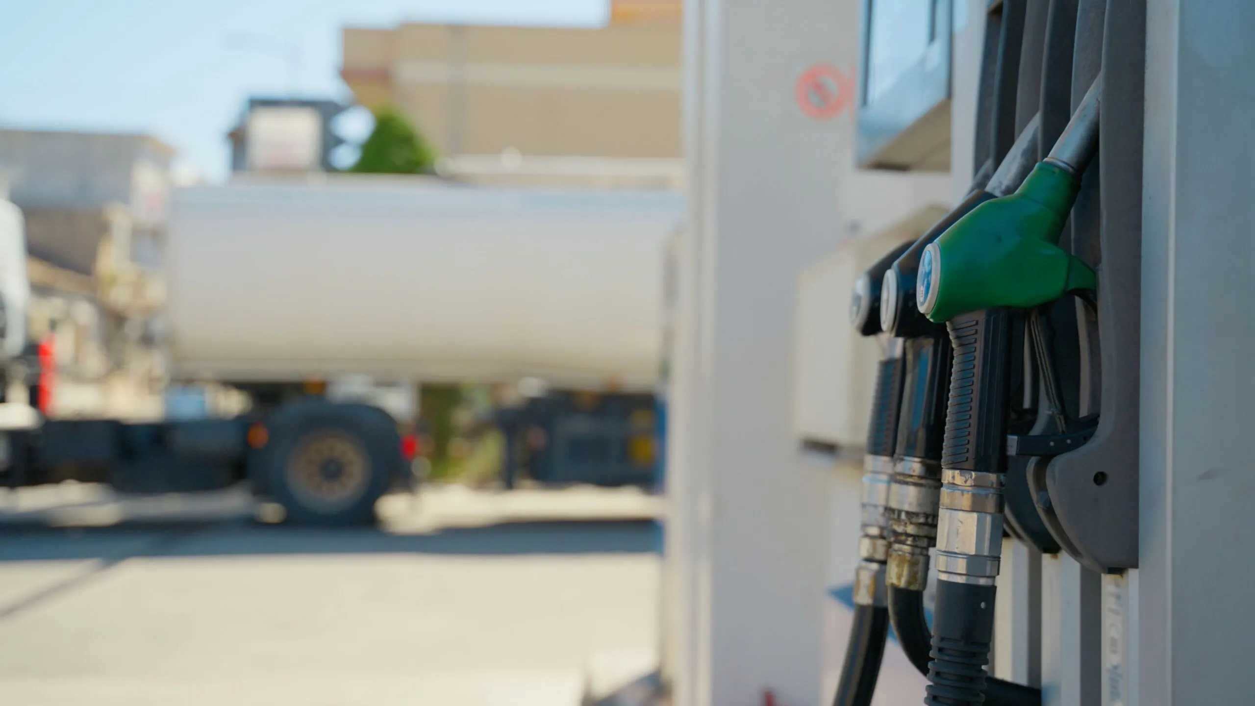 gas pumps with truck in back, rising fuel costs