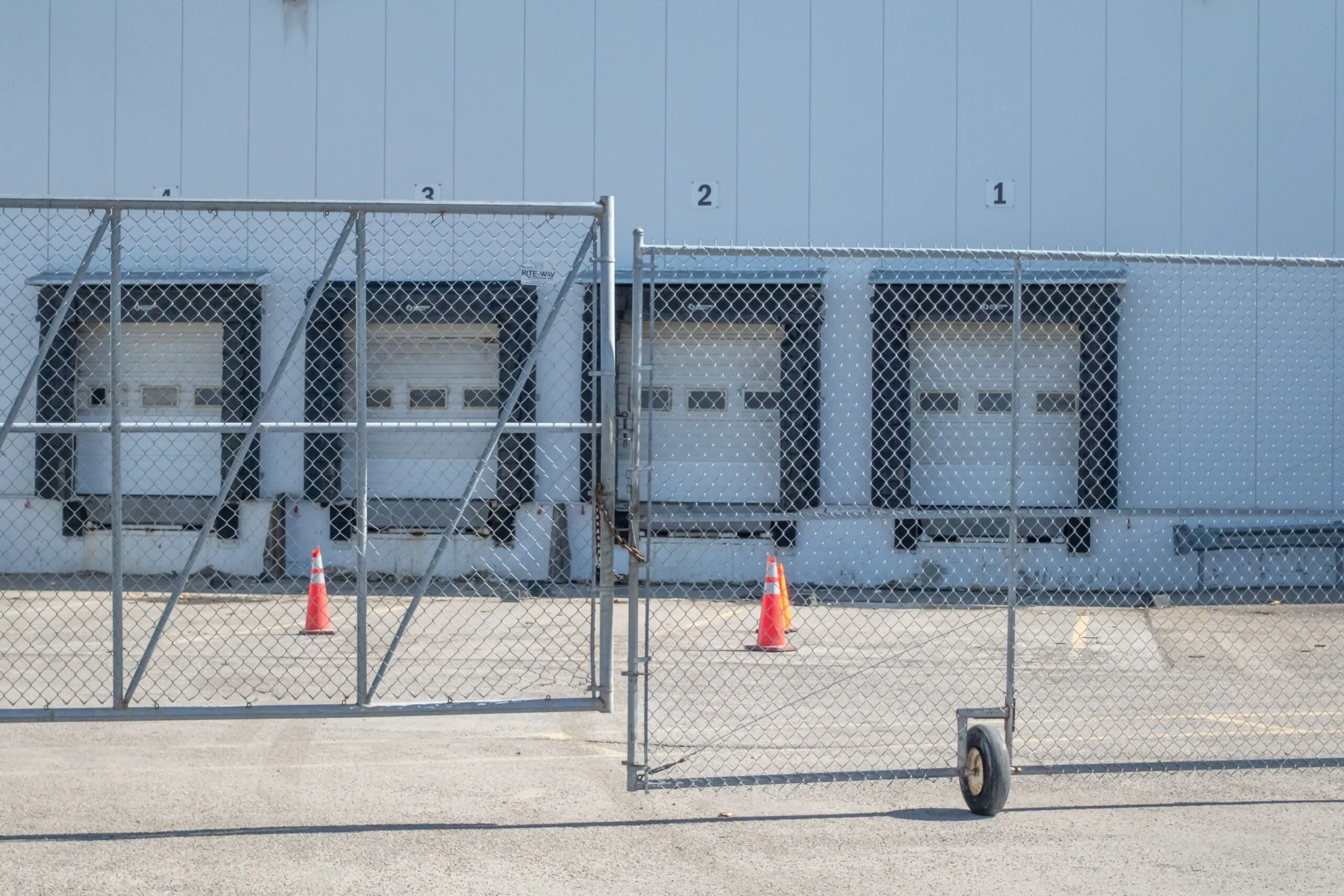loading dock behind gates, shipping delay causes