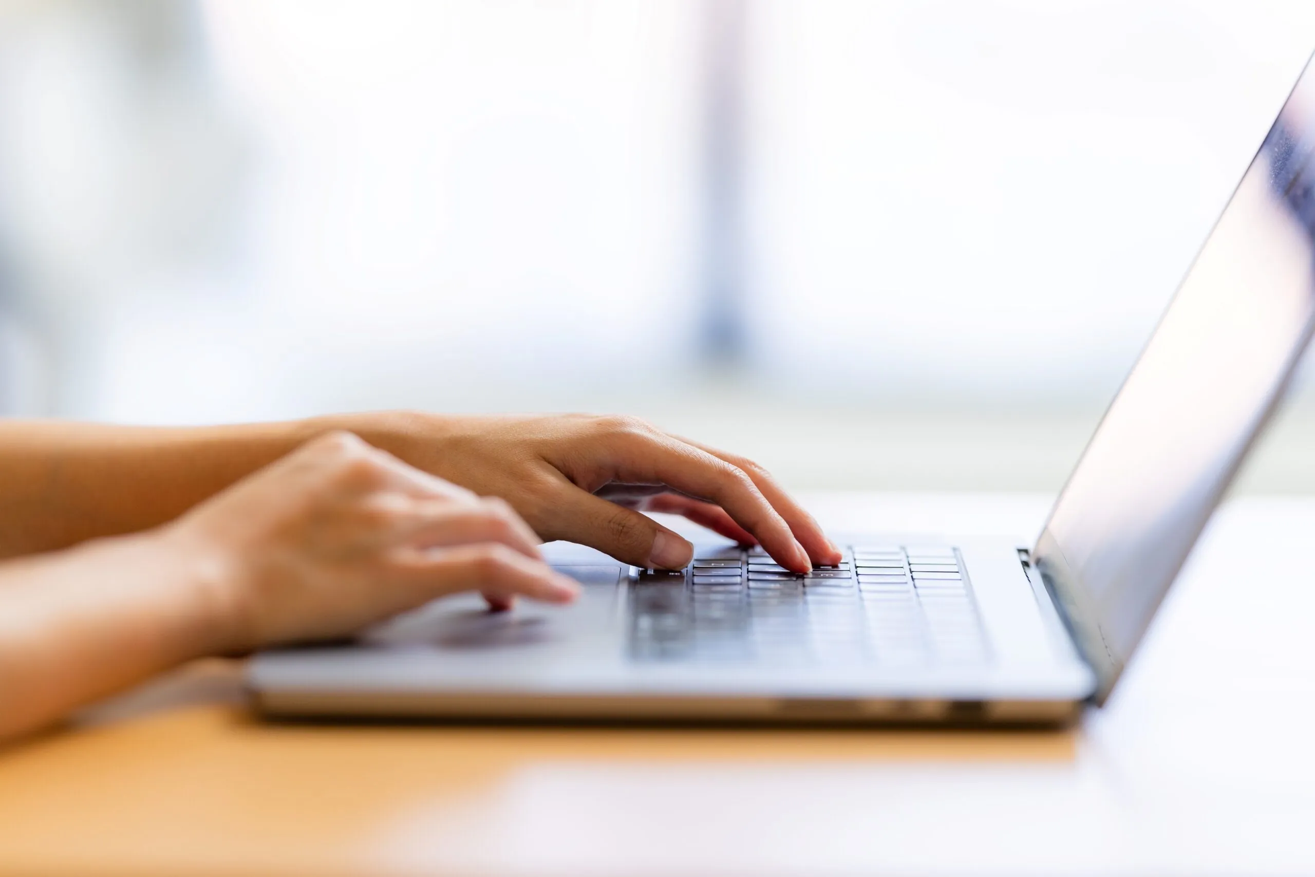person typing on computer keyboard