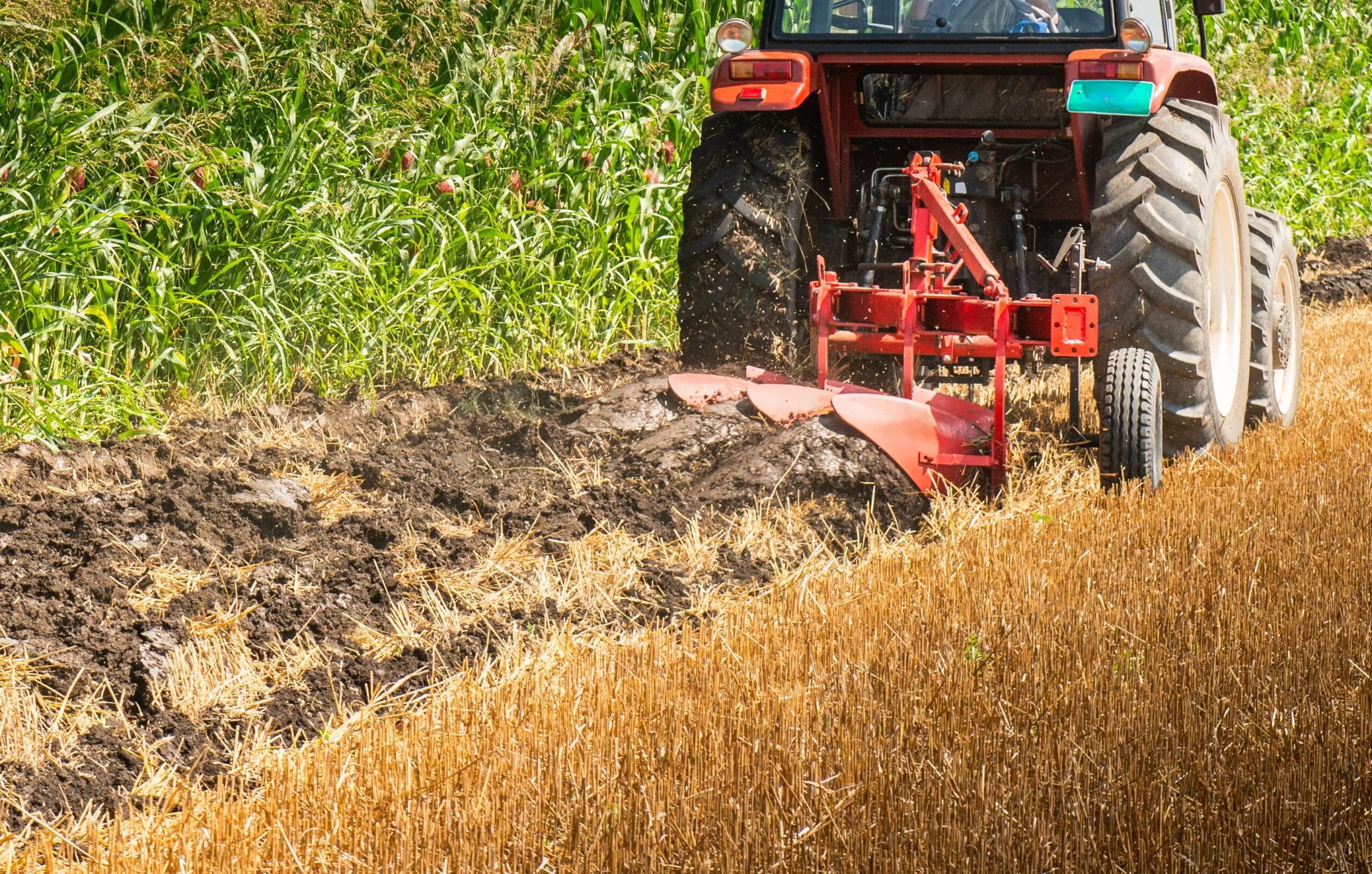tractor plows farm land