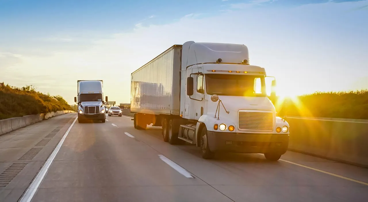 freight shipping trucks sunset driving