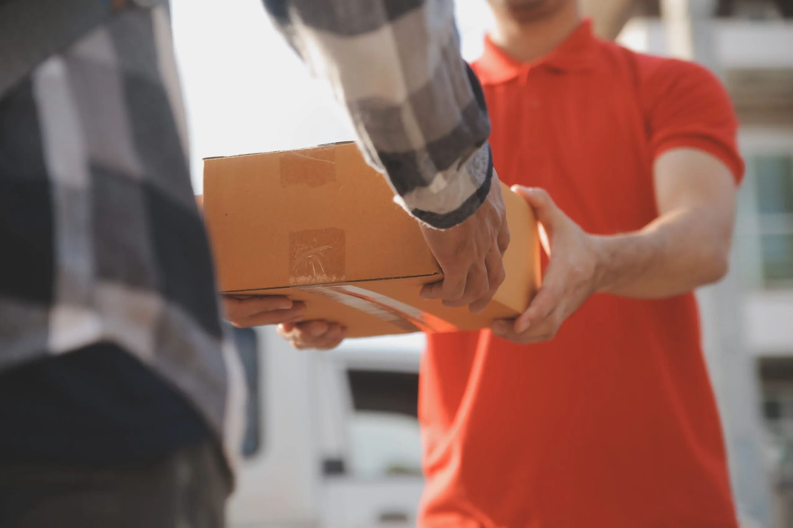 man handing over package to consumer