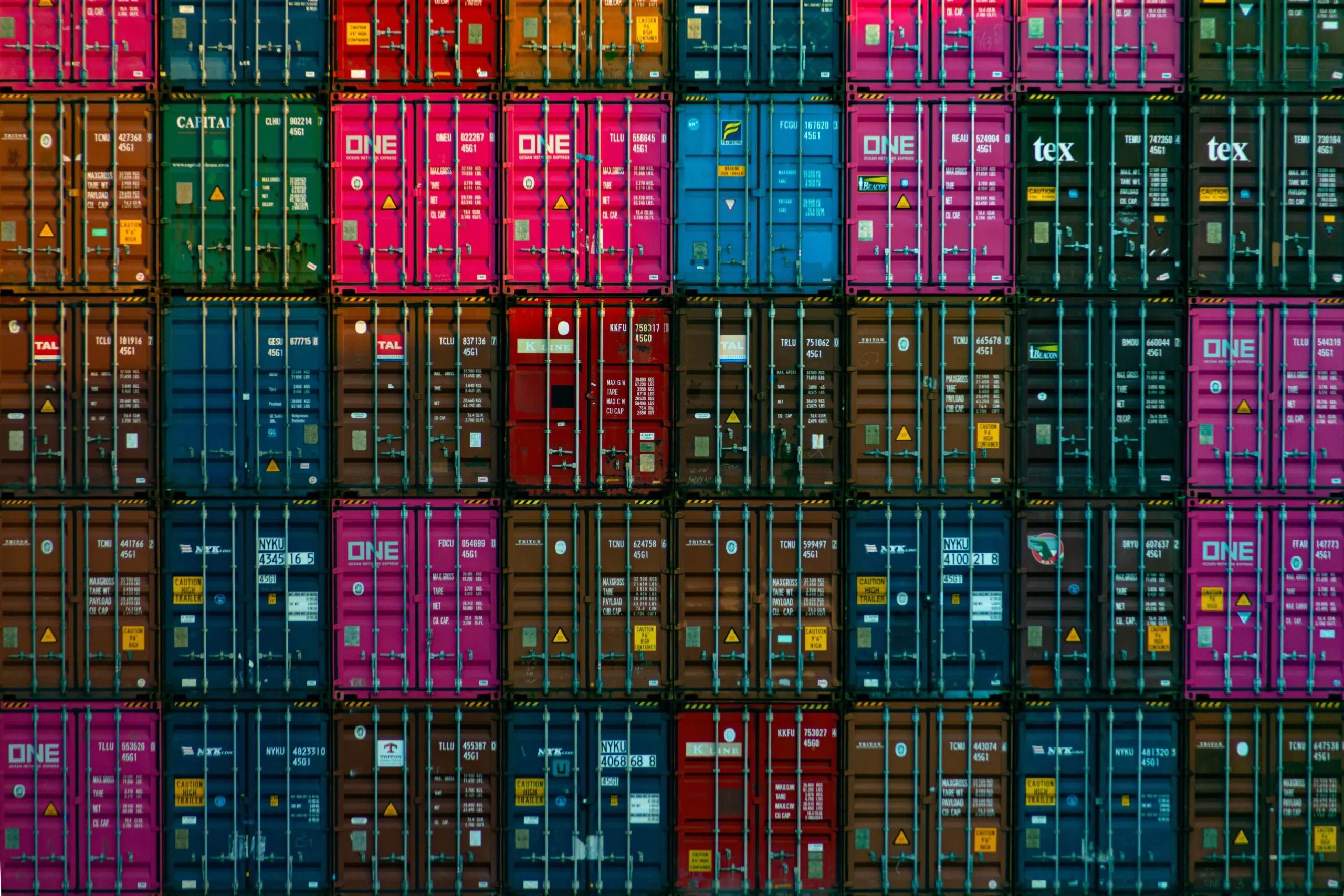 AI Makes Shipping Smarter Optimizing Space when Stacking Containers. Many container colors stacked neatly.