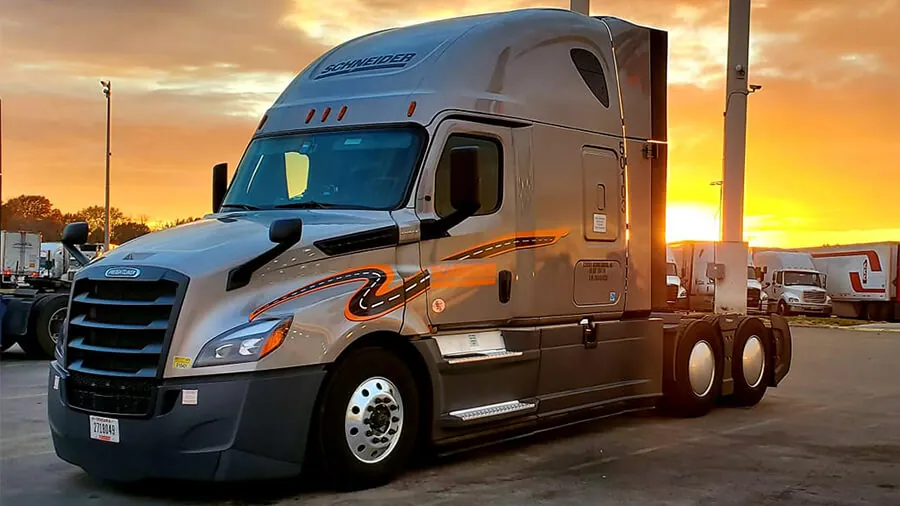 Schneider freight truck parked at sunrise