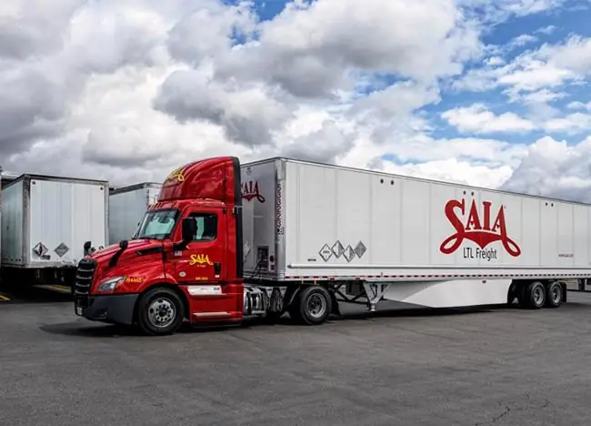 red and white SAIA truck parked at a SAIA terminal