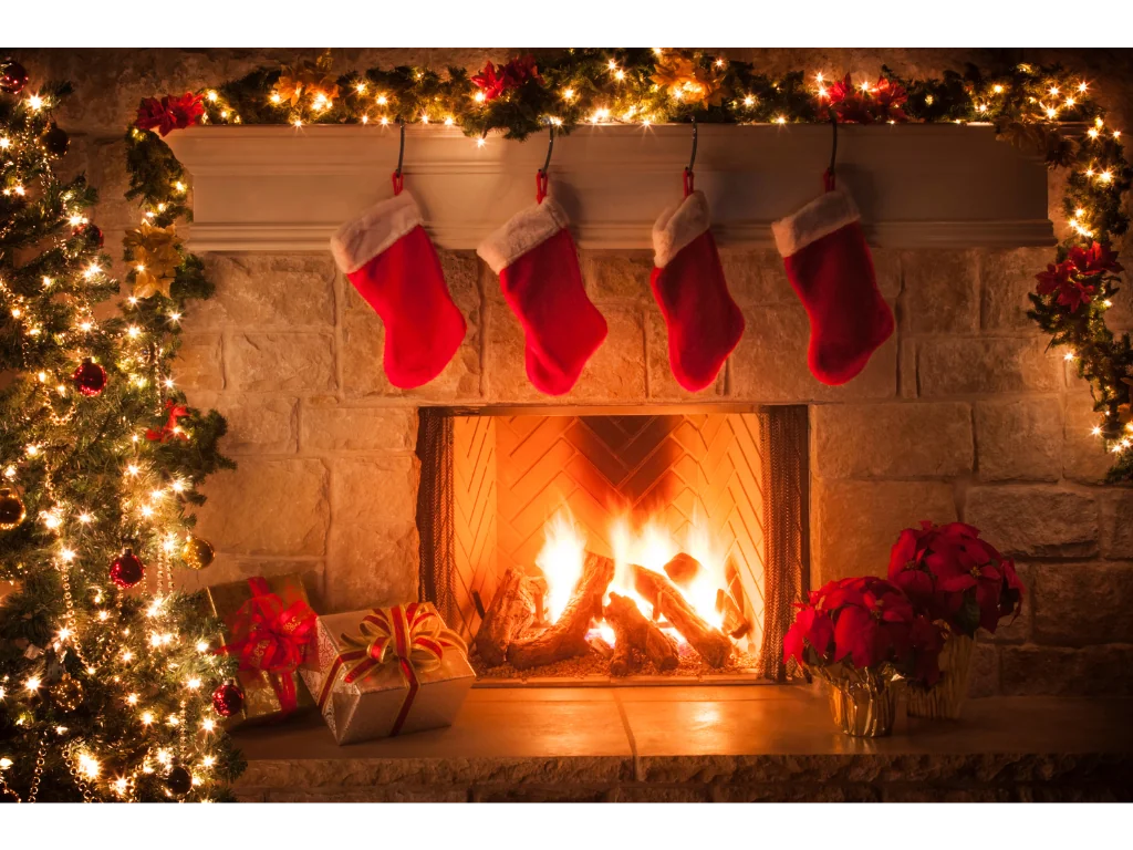 Christmas decorations and stocking hanging over a fireplace