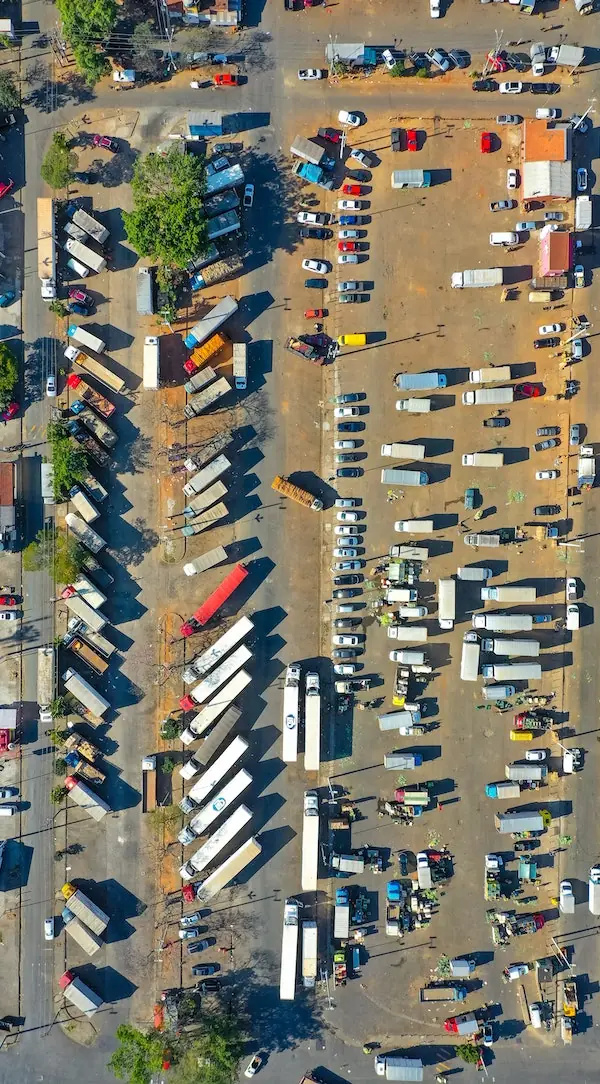 top down view of many dry van trucks in a terminal
