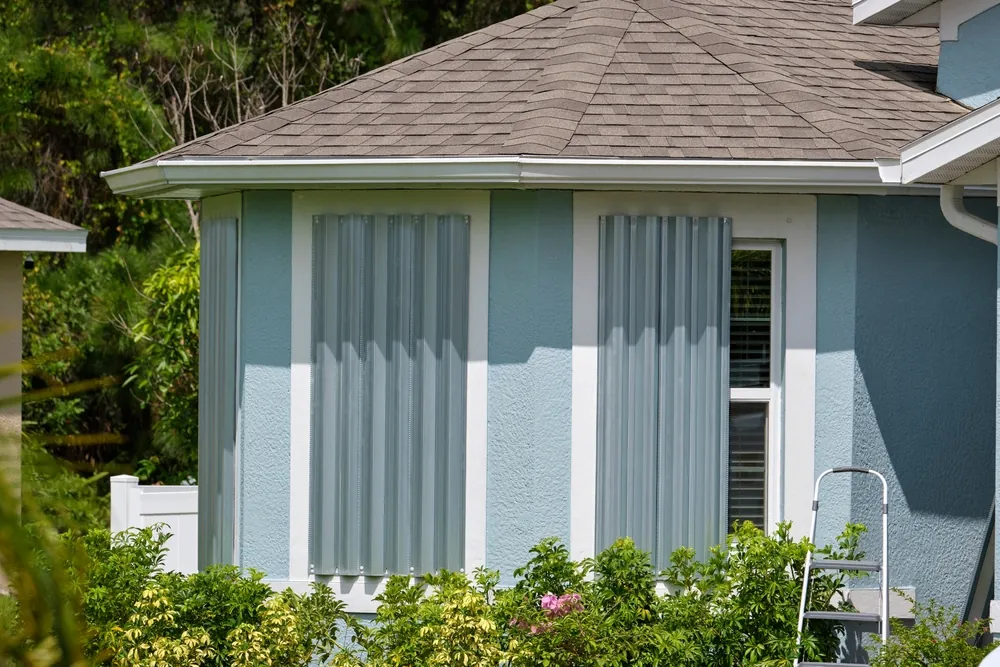 boarded up house with aluminum hurricane shutters