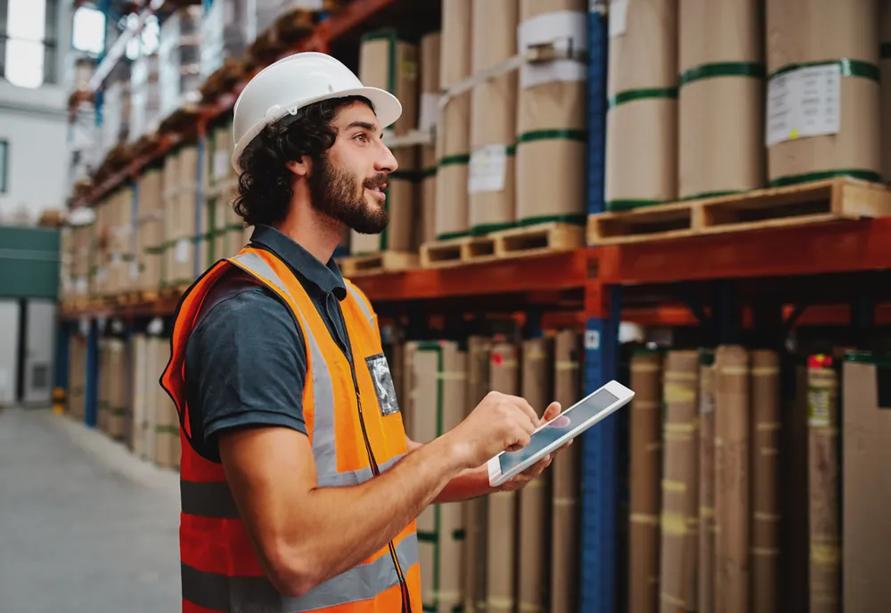 Warehouse employee with a tablet taking inventory