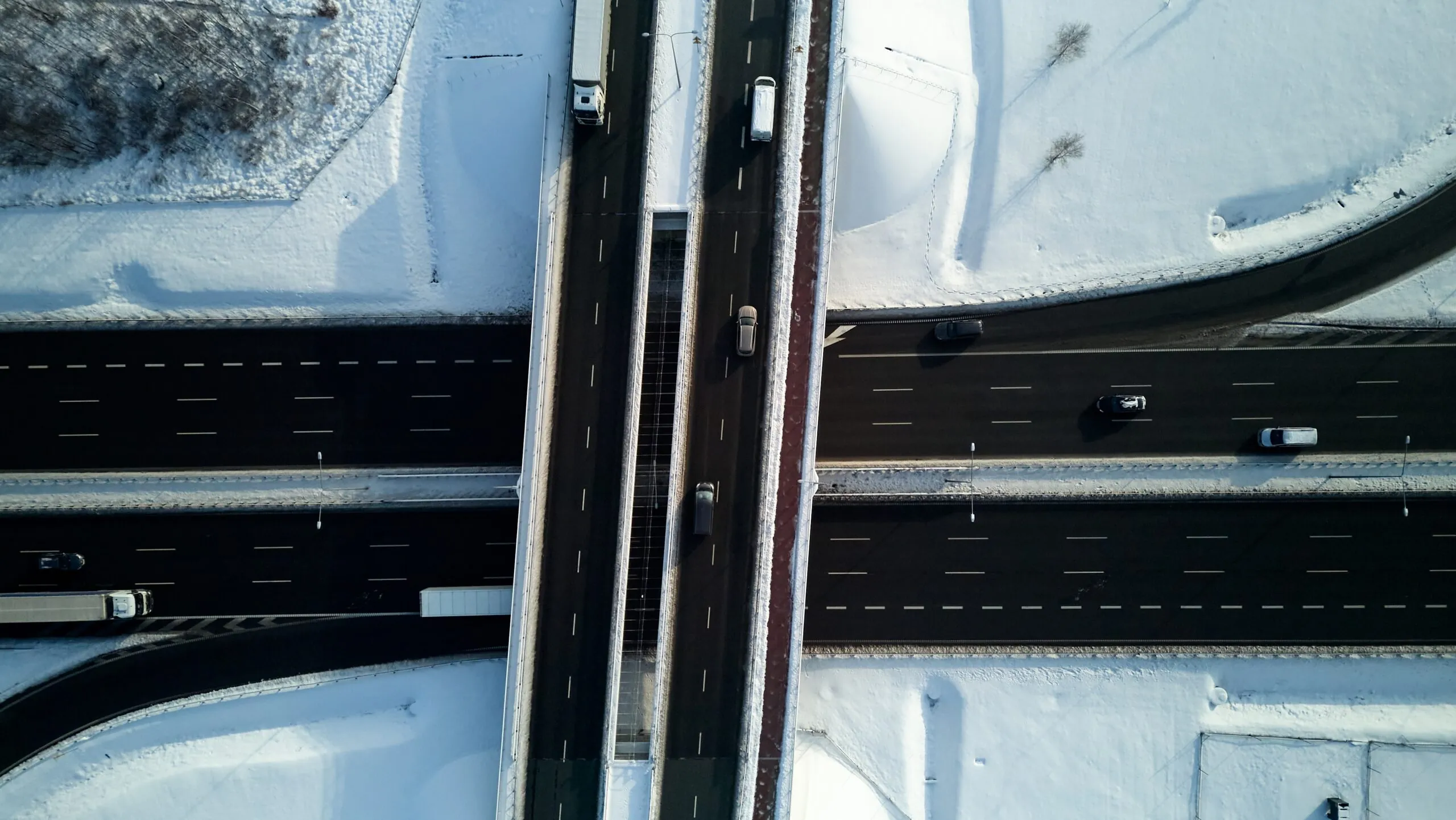 aerial view of cars and trucks on snowy highway