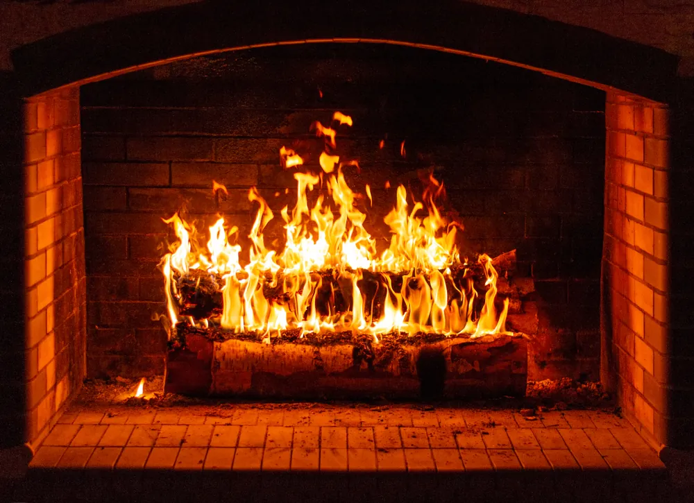 glowing fire in a huge stone fireplace