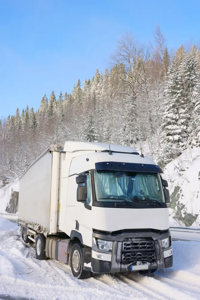truck hauling winter container snowy road