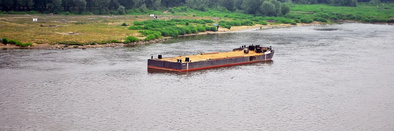 barge sailing down a river