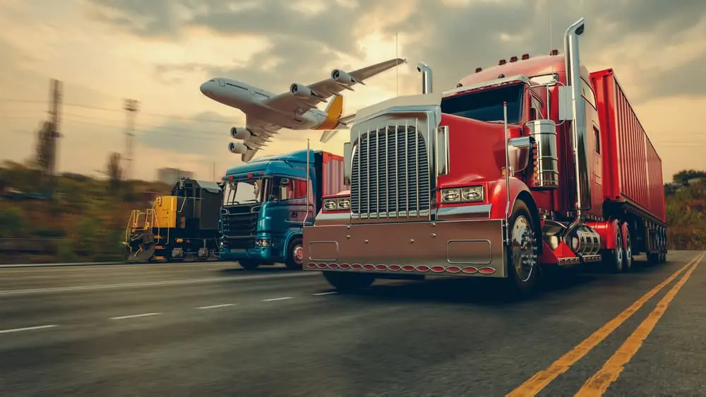 a truck, plane, and train lined up on a highway with a blurred backround