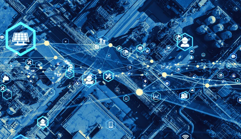 top down view of a city with a blue color overlay and network lines meant to represent technology and the supply chain