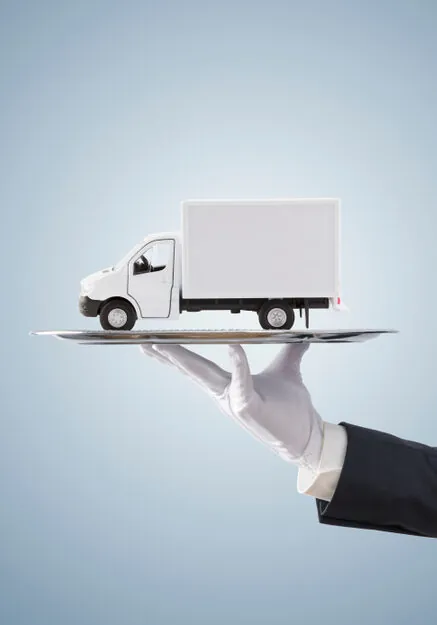 white gloved hand delivering a box truck of household goods on a platter