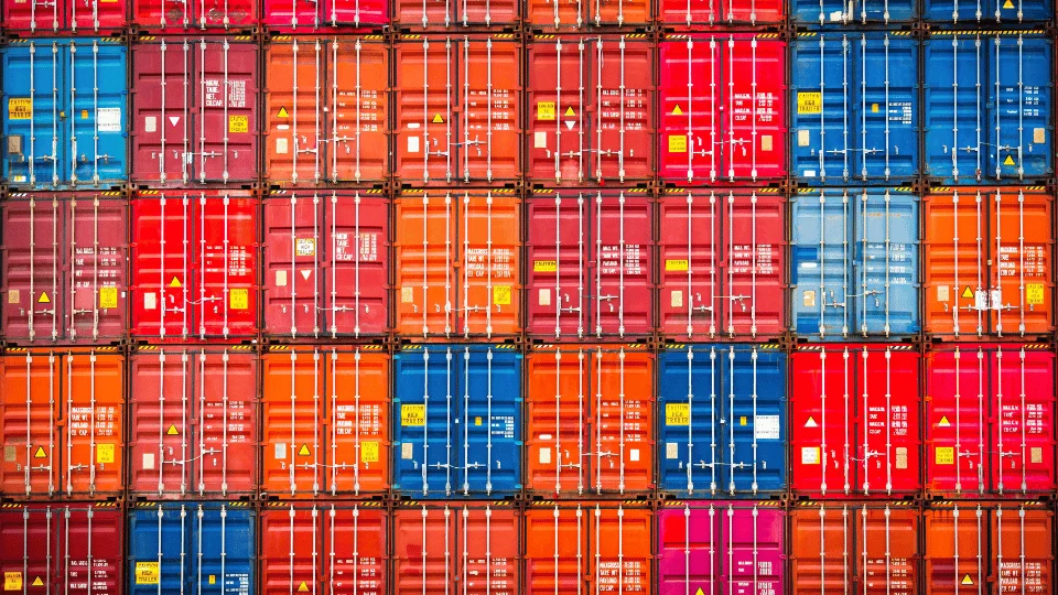 15 Interesting Facts About Shipping Containers rows of stacked colorful shipping containers BLOG VERSION