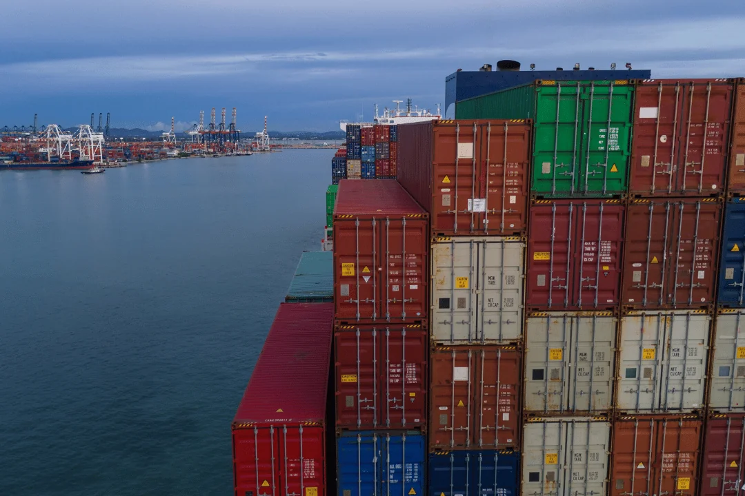 15 Interesting Facts About Shipping Containers shipping container stack overlooking the water across from port in the evening