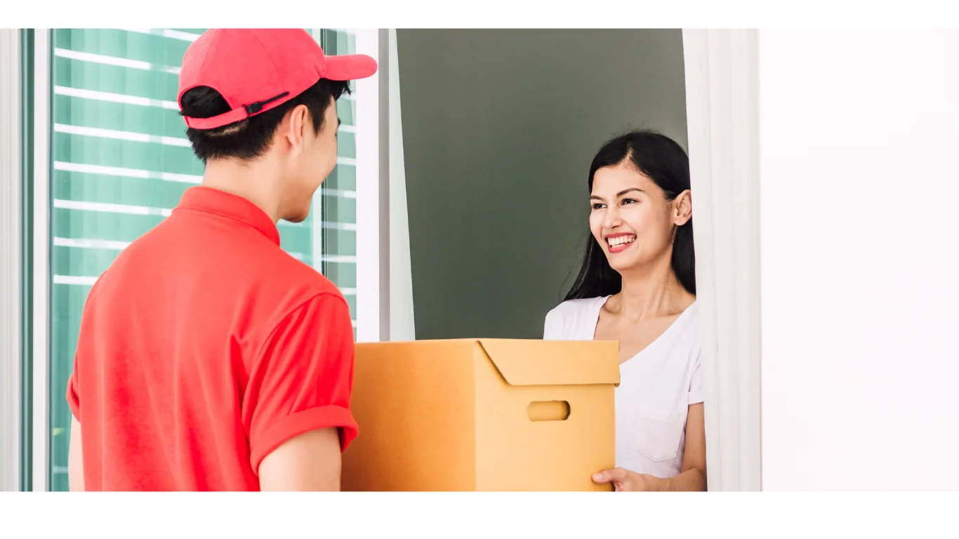man in red shirt delivering a package to a women