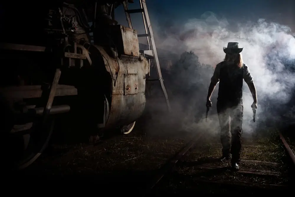 Train Robberies cowboy approaching freight train on a foggy dark night