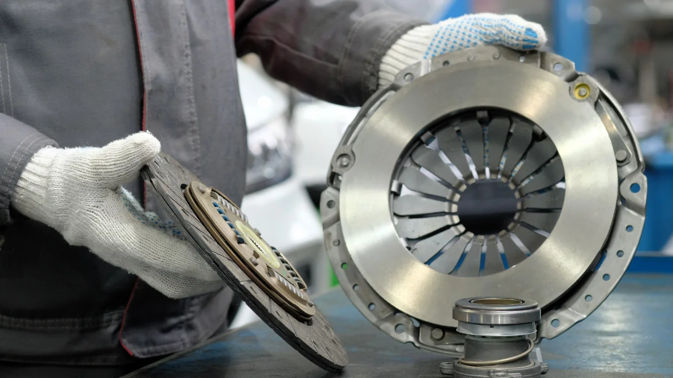hands holding automobile clutch kit