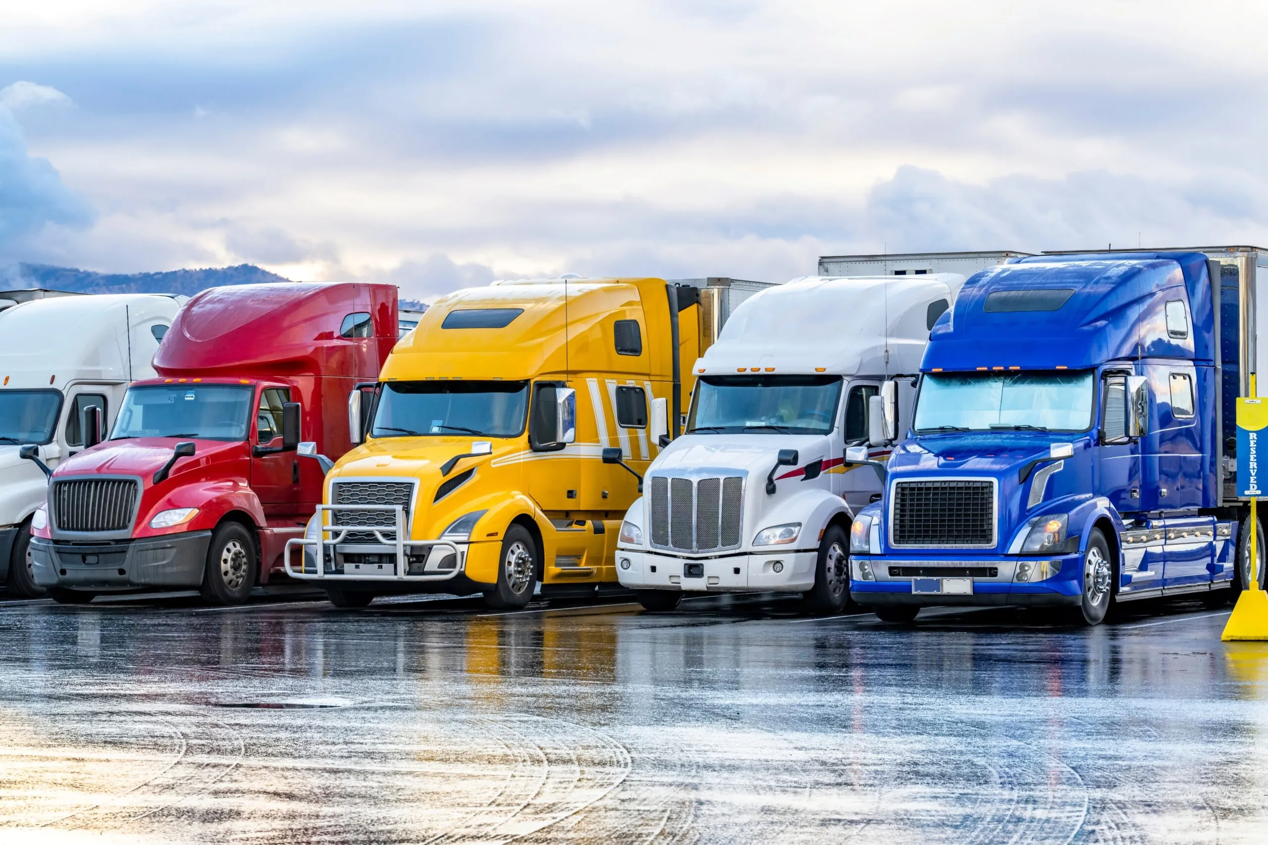 colored semi trucks parked in a row