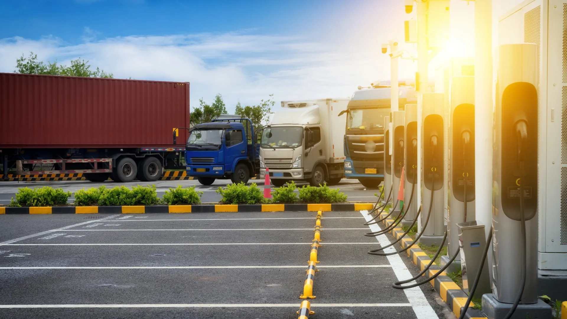 ev trucks and chargers in logistics hub parking
