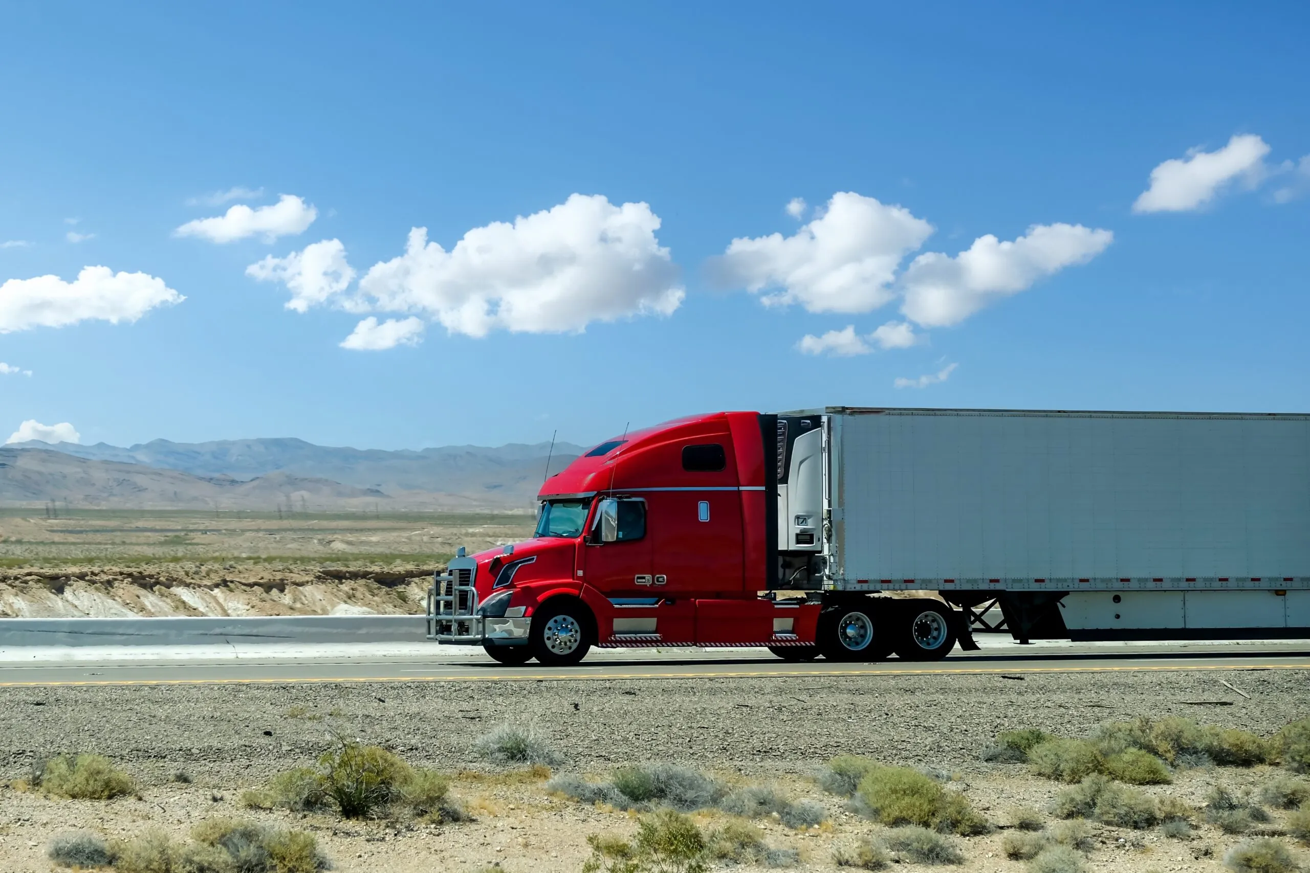 semi truck driving on desert highway