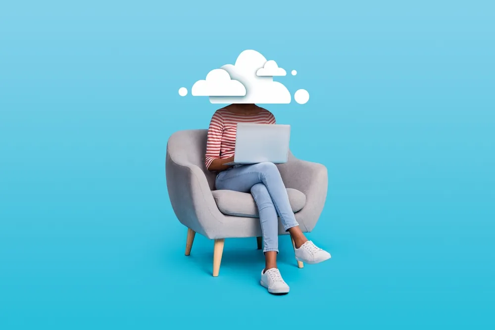 women sitting at computer and a cloud covering her head 