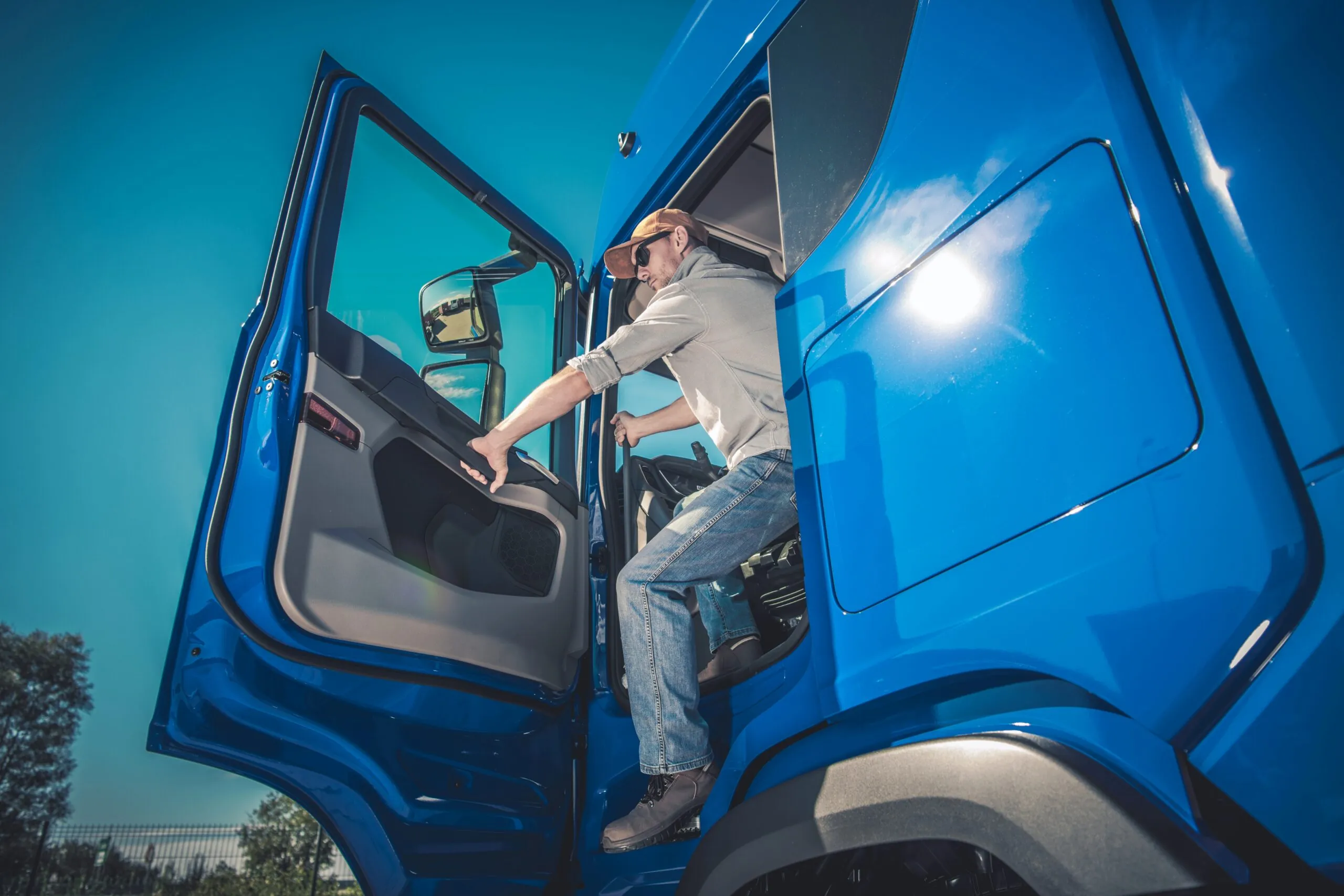 truck driver stepping out of truck cab