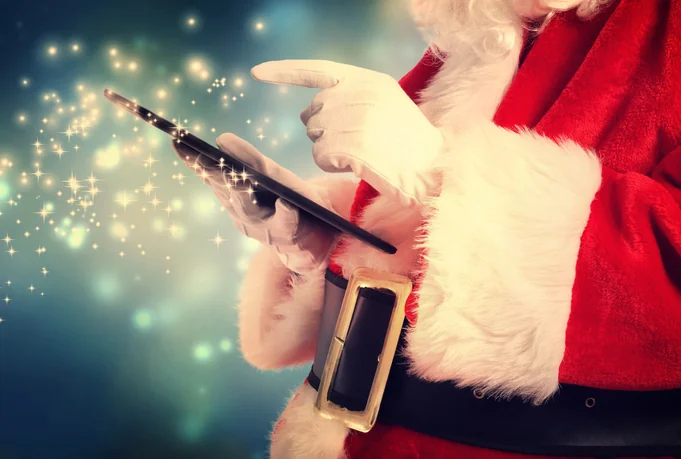 holiday shipping season santa with tablet