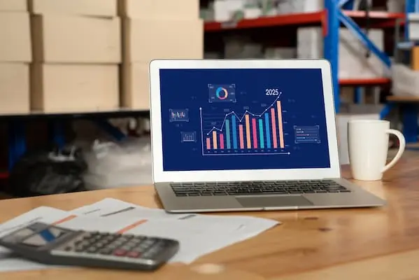 Is Your Freight Shipping Strategy Costing You Customers shipping analytics on a laptop in a warehouse desk PREVIEW VERSION