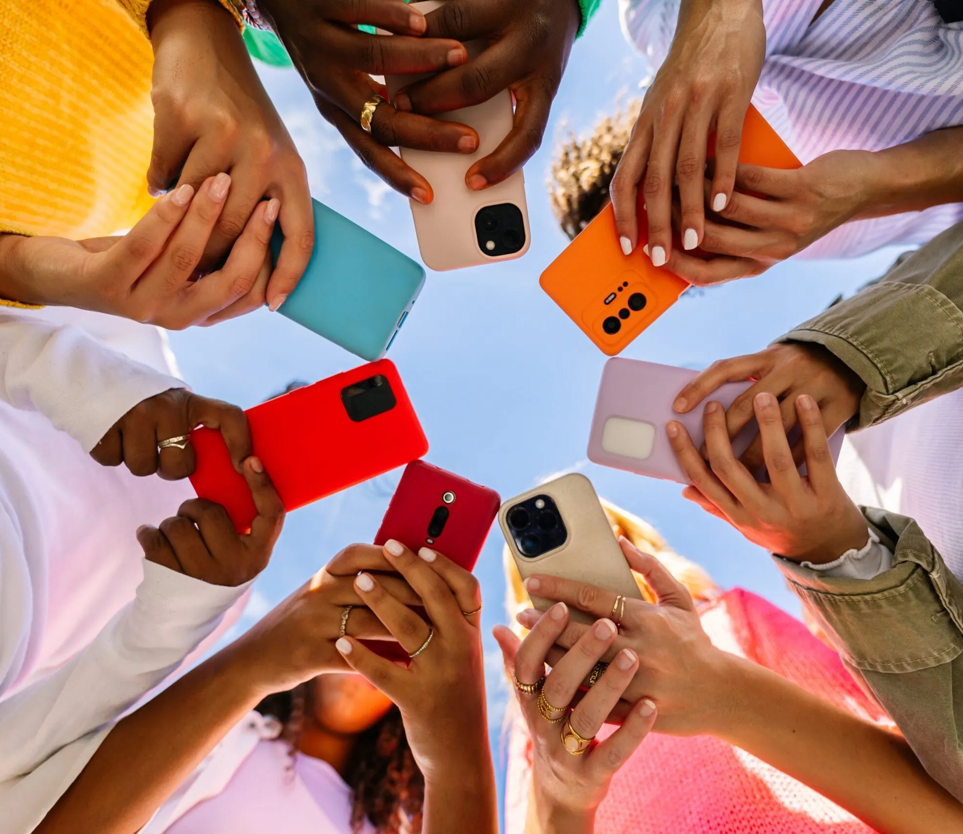 young people on phones standing in circle