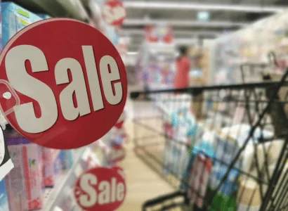 red round sale sign in a grocery store