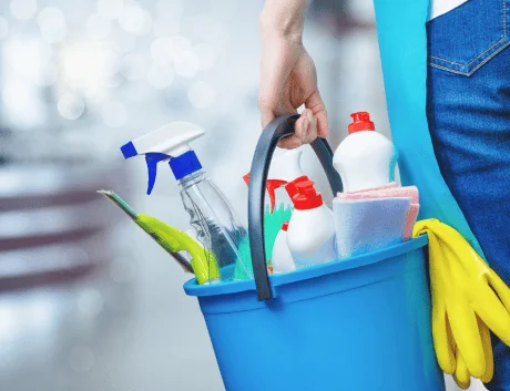 woman worker carrying bucket of cleaning products