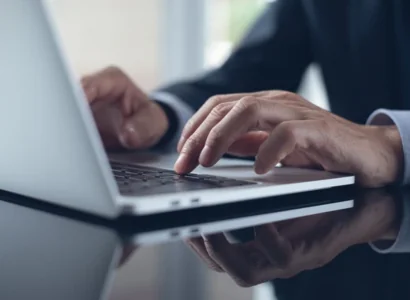 man on laptop using freight tms technology