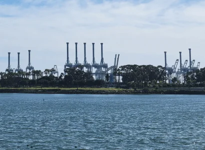 Barge Shipping view of cranes at the Port of Long Beach CA via river