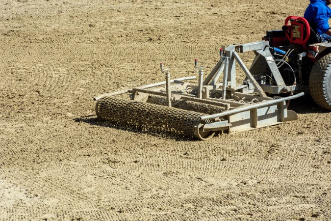 Packaging Machinery Equipment close up of a tractor preparing an equestrian field