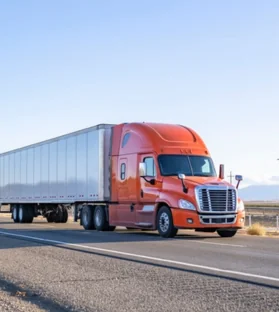 Blue and orange truck driving on highway