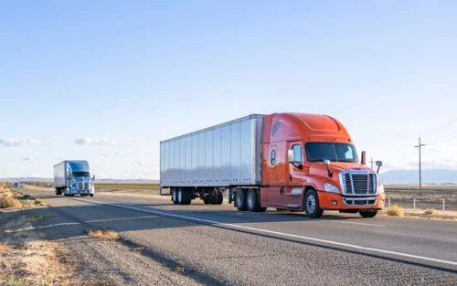 Blue and orange truck driving on highway