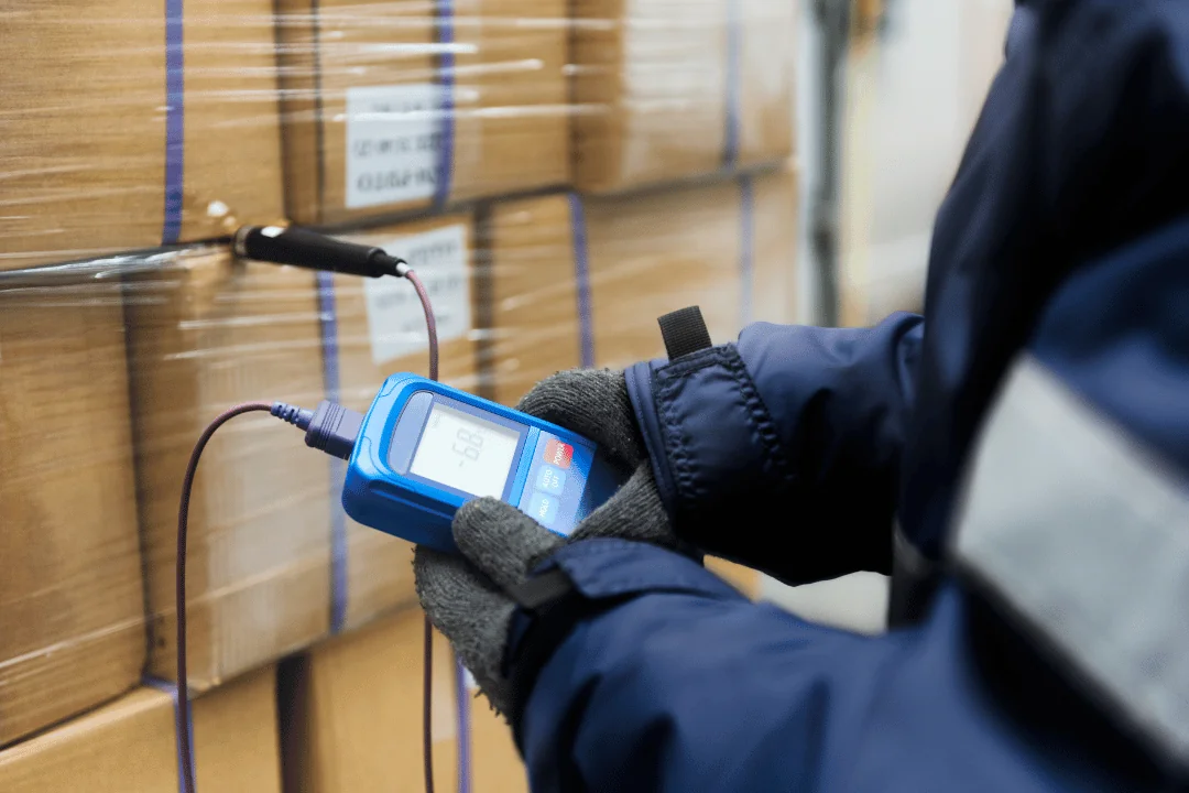 cold storage warehouse worker checking temperature of cold freight