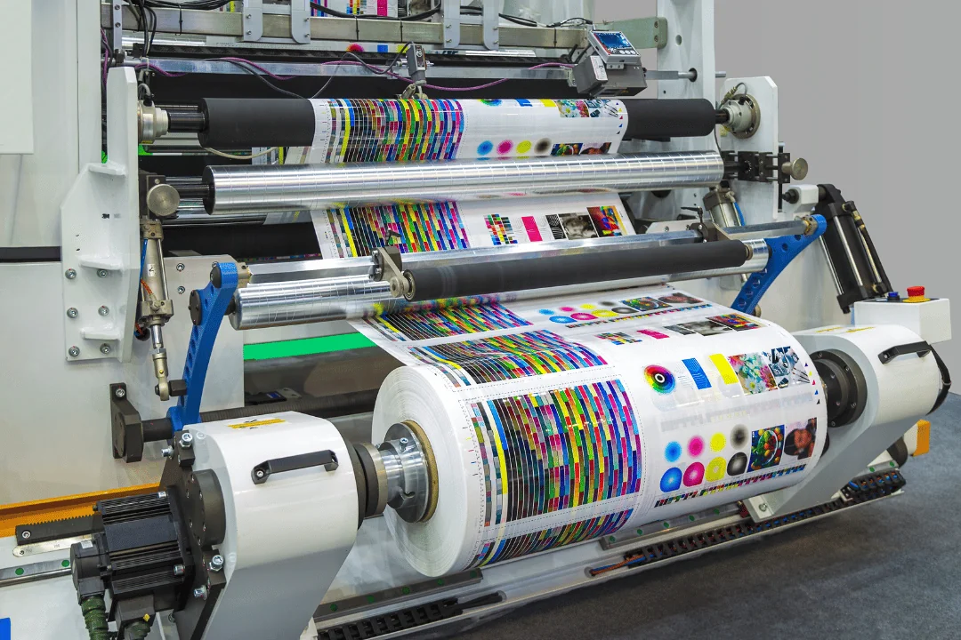 Printing Press Shipping industrial printing press on display with sample paper rolled on