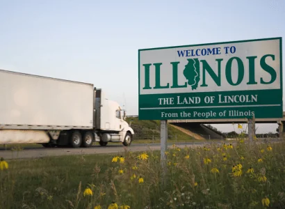Printing Press Shipping white truck passing by Welcome to Illinois The Land of Lincoln sign on highway