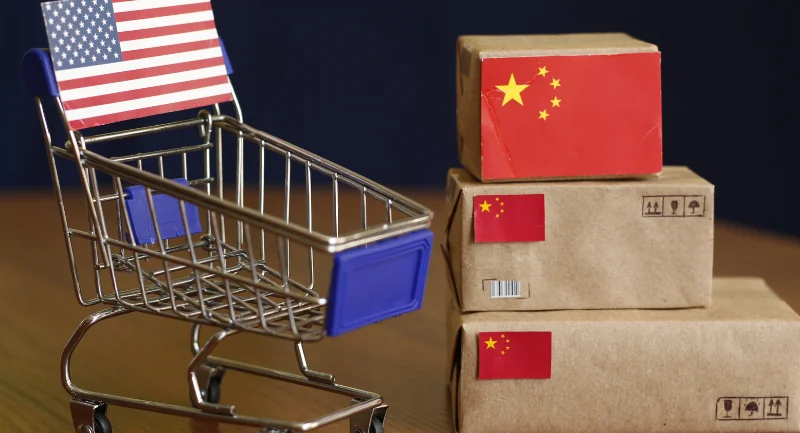 small miniature boxes with china flag and miniature shopping cart with American flag