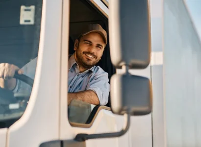 Happy professional truck driver driving his truck