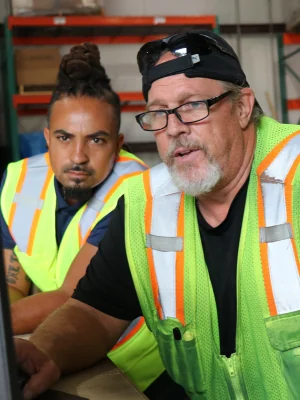 warehouse manager and shipping agent working on a computer